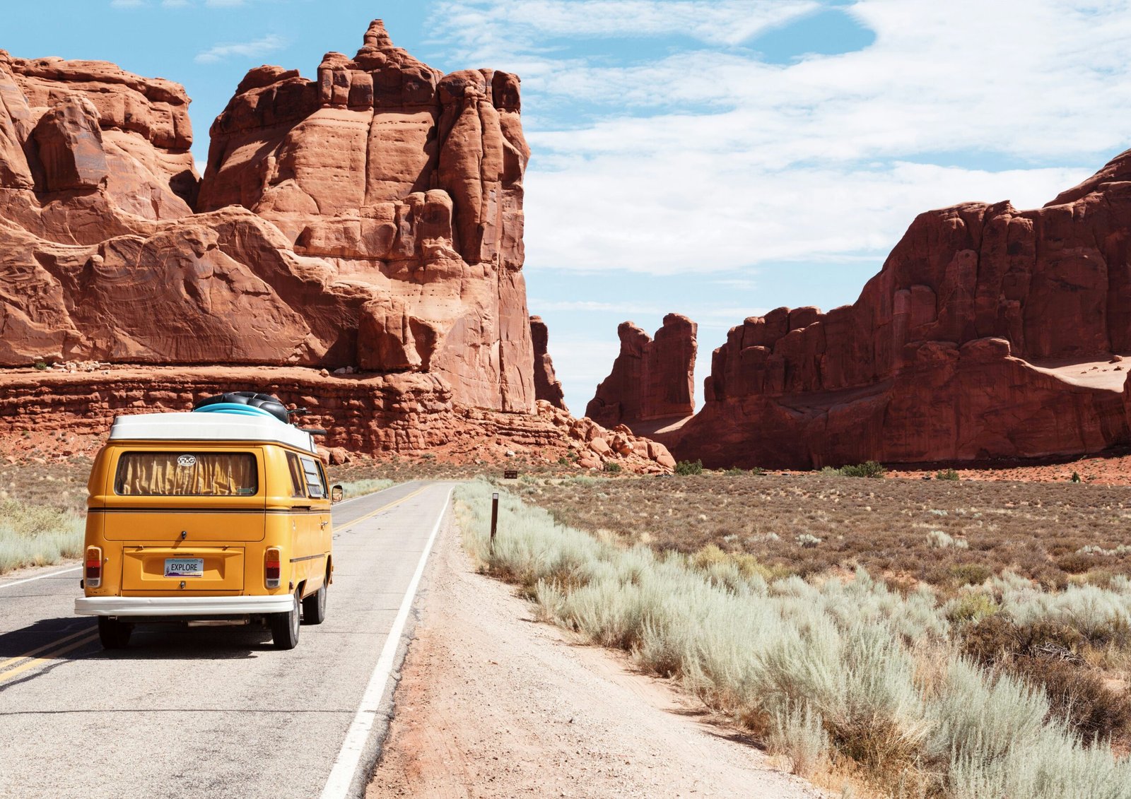 Yellow travel van on the road.